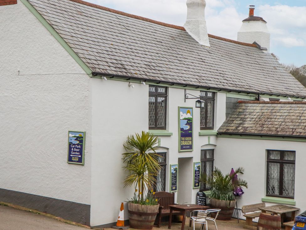 An outdoor pub with a sign at The Green Dragon in Stoke Fleming