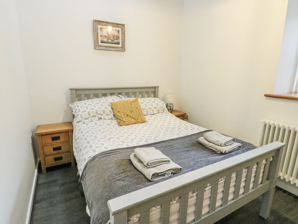 A bedroom with a bed and bedside tables at 2 Mountain View Talwrn near Llangefni