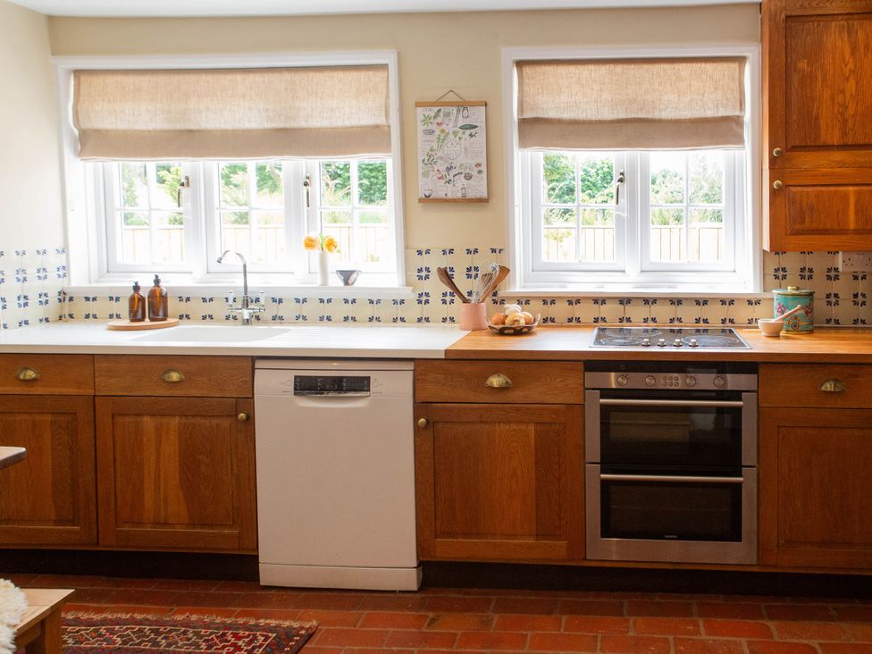 A kitchen with a sink and oven at Newstead Farmhouse in East Chiltington near Lewes, Sussex