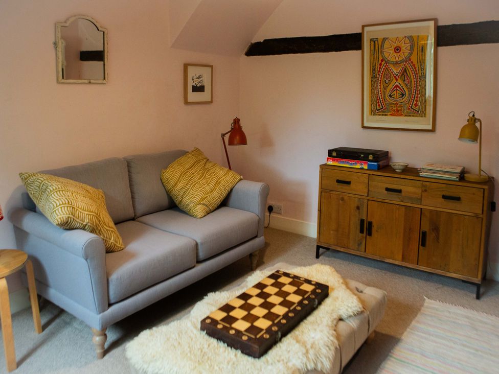 A snug with a sofa and chessboard at Newstead Farmhouse in East Chiltington near Lewes, Sussex