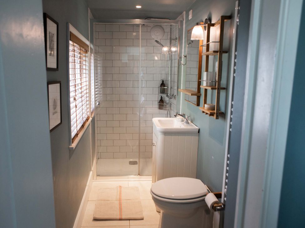 A bathroom with a shower and sink at Newstead Farmhouse, East Chiltington near Lewes, Sussex