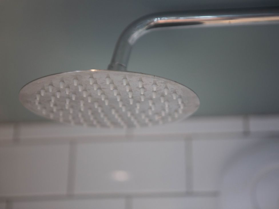 A shower head in a bathroom at Newstead Farmhouse East Chiltington near Lewes Sussex