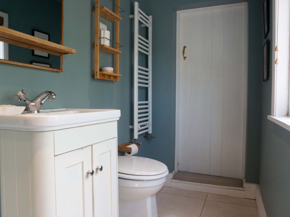 A bathroom with a sink and toilet at Newstead Farmhouse in East Chiltington near Lewes, Sussex