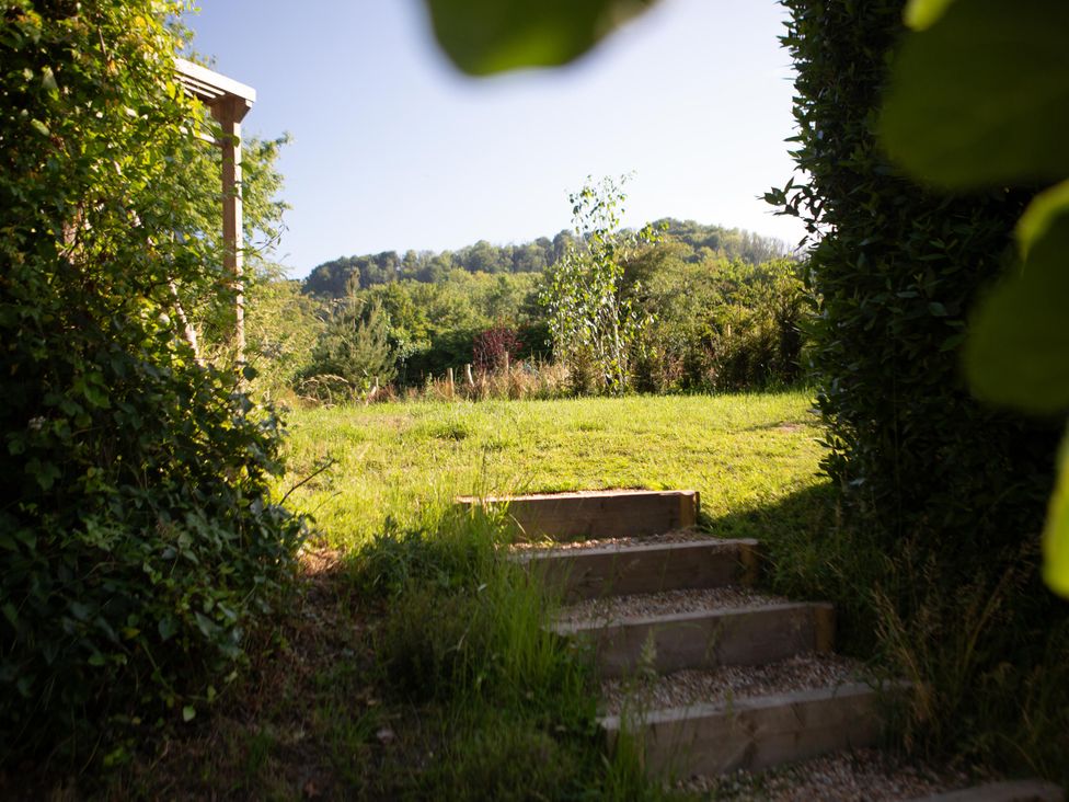 A garden with steps leading to grassy area at Newstead Farmhouse in East Chiltington near Lewes, Sussex