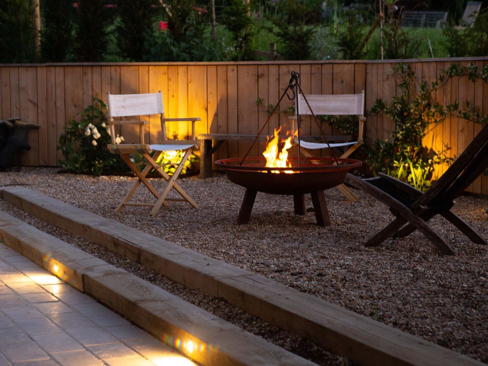 A garden with a fire pit and chairs at Newstead Farmhouse East Chiltington near Lewes, Sussex