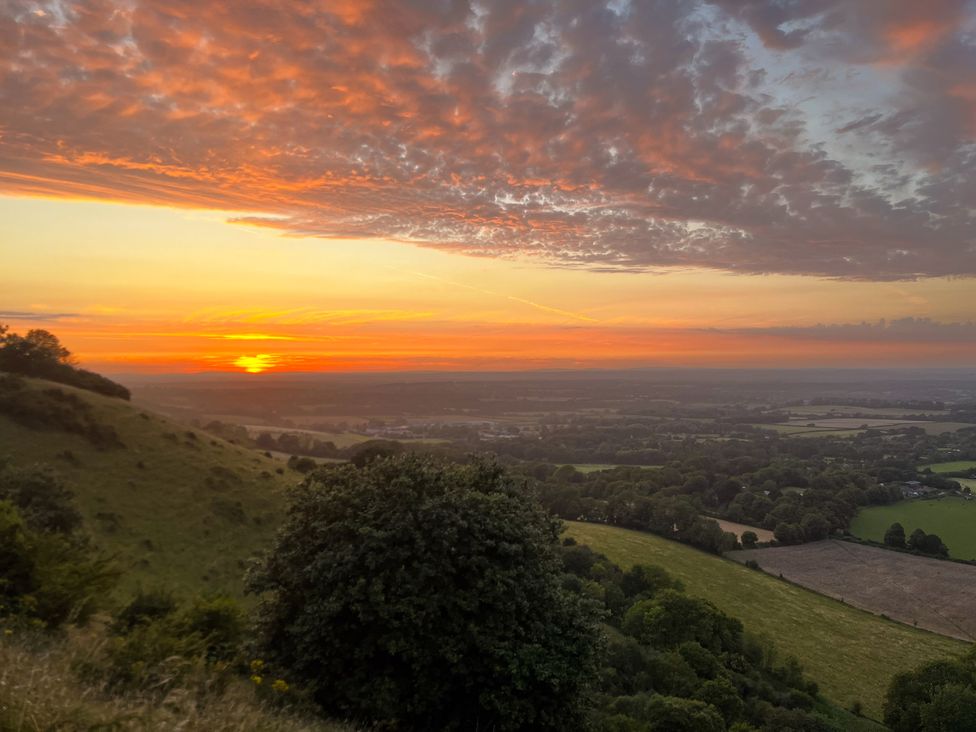 A landscape view of hills and fields during sunset at Newstead Farmhouse East Chiltington near Lewes, Sussex