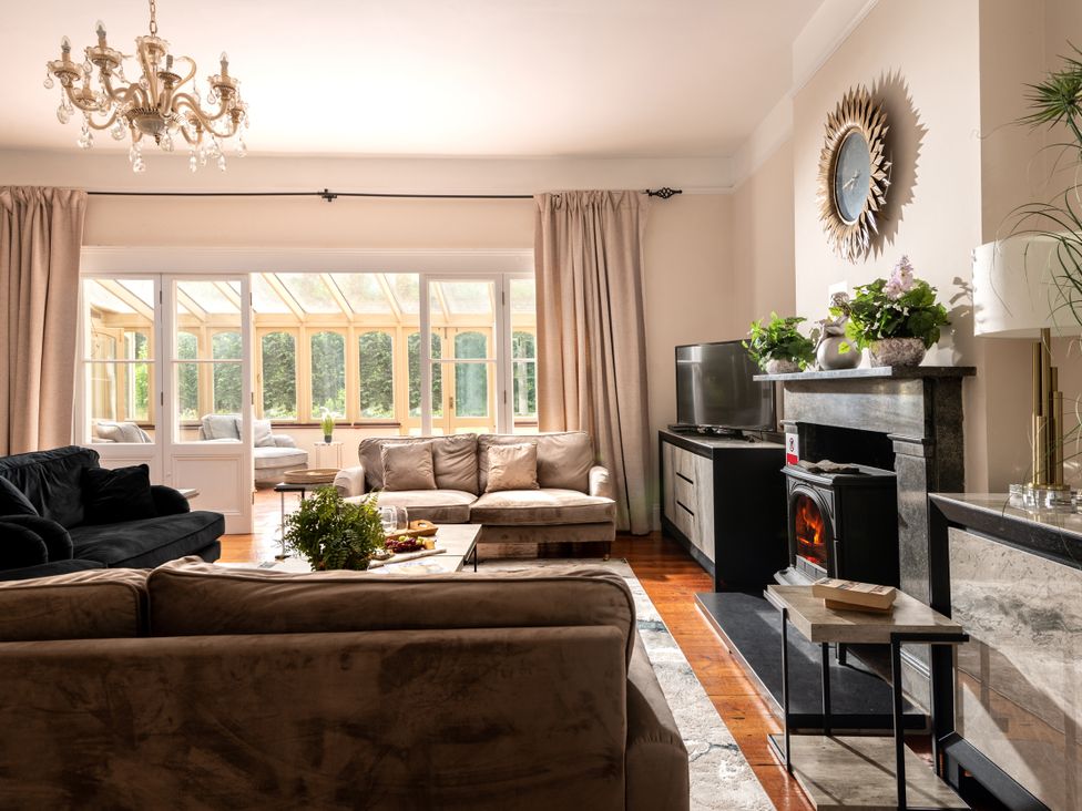 A living room with sofas and a fireplace at The Downwood in Blandford Forum