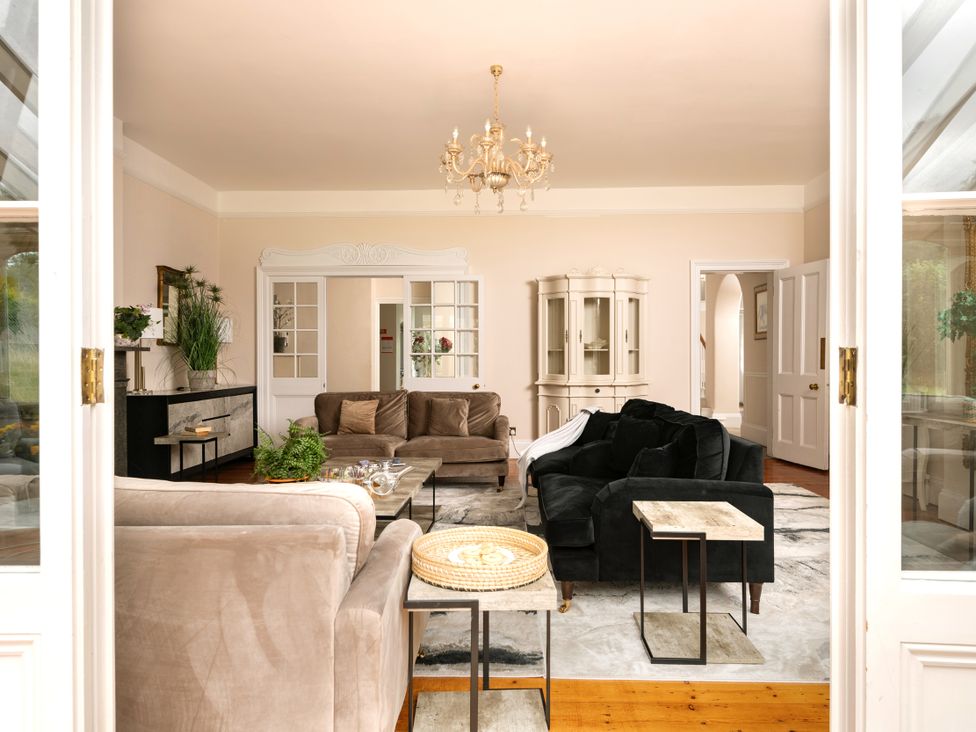 A living room with sofas and a coffee table at The Downwood in Blandford Forum