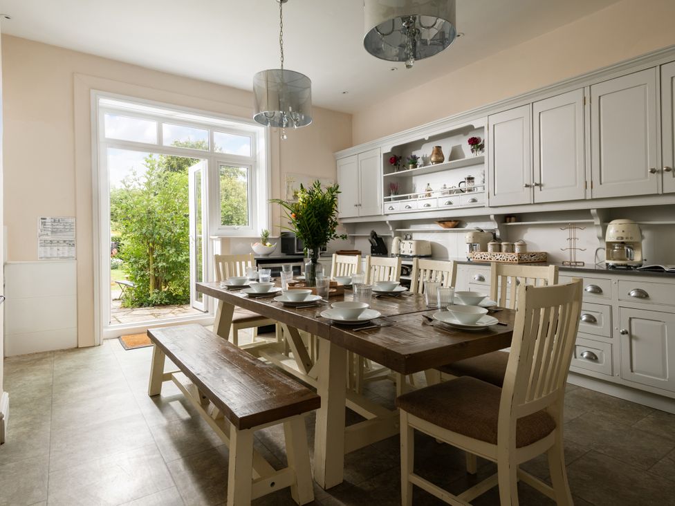 A kitchen with a dining table and chairs at The Downwood in Blandford Forum