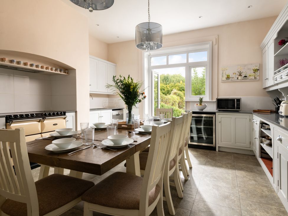 A kitchen with a dining table and chairs at The Downwood in Blandford Forum