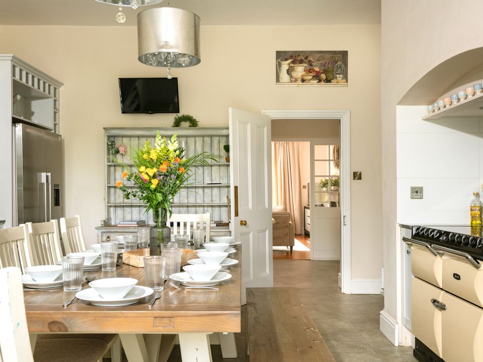 A kitchen with a dining table and chairs at The Downwood in Blandford Forum