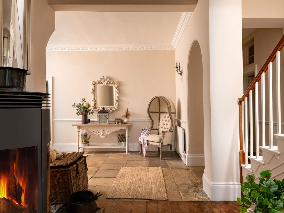 A hallway with a table and chair at The Downwood in Blandford Forum
