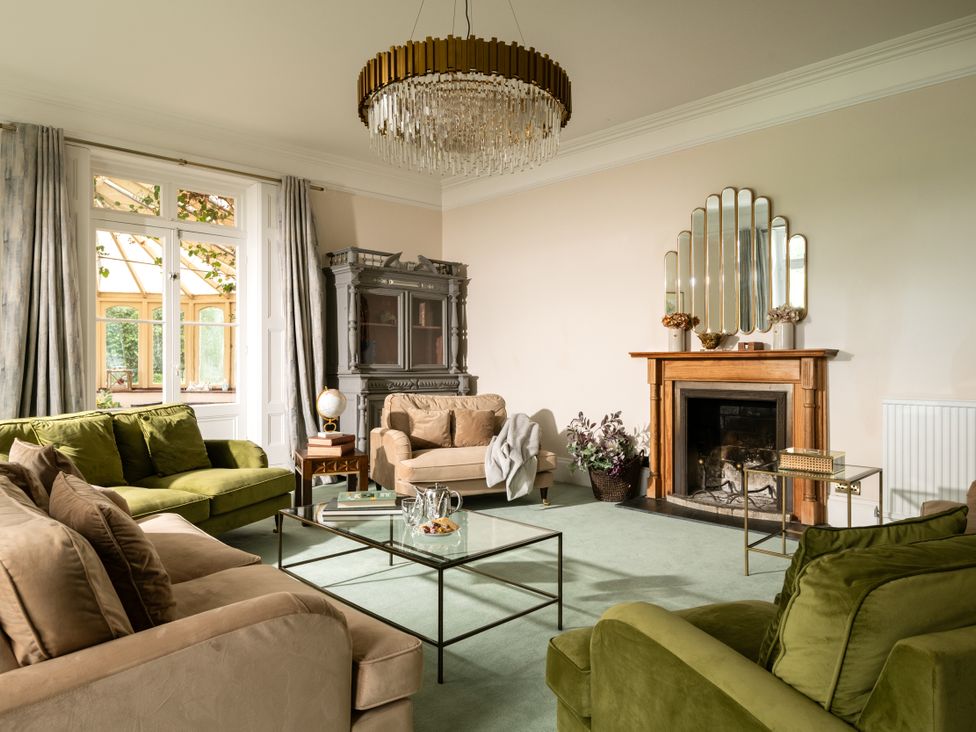 A living room with sofas and a fireplace at The Downwood in Blandford Forum