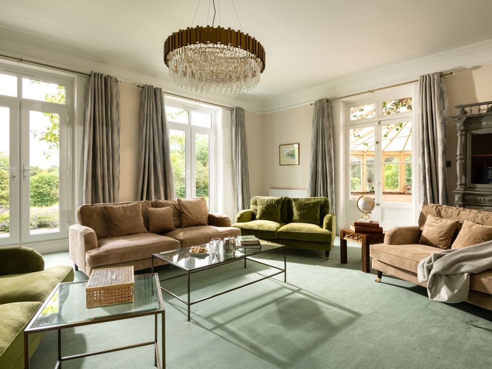 A living room with sofas and a coffee table at The Downwood in Blandford Forum