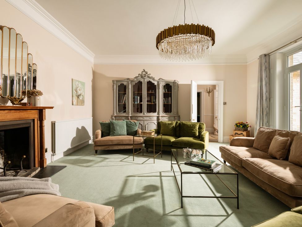 A living room with a fireplace and seating area at The Downwood in Blandford Forum