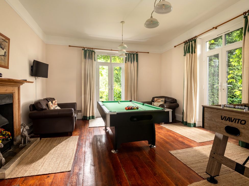 A game room with a pool table and television at The Downwood in Blandford Forum