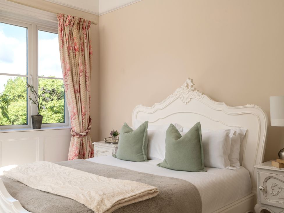 A bedroom with a bed and nightstand at The Downwood in Blandford Forum