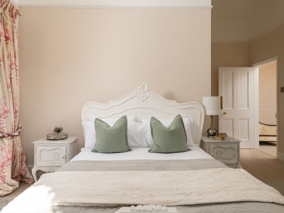 A bedroom with a bed and bedside table at The Downwood in Blandford Forum