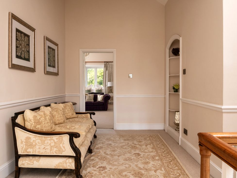 An entryway with a sofa and pictures at The Downwood in Blandford Forum