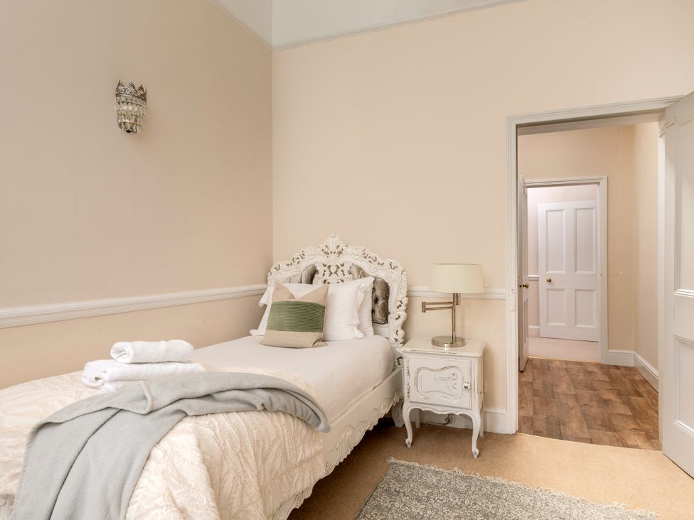 A bedroom with a bed and nightstand at The Downwood in Blandford Forum