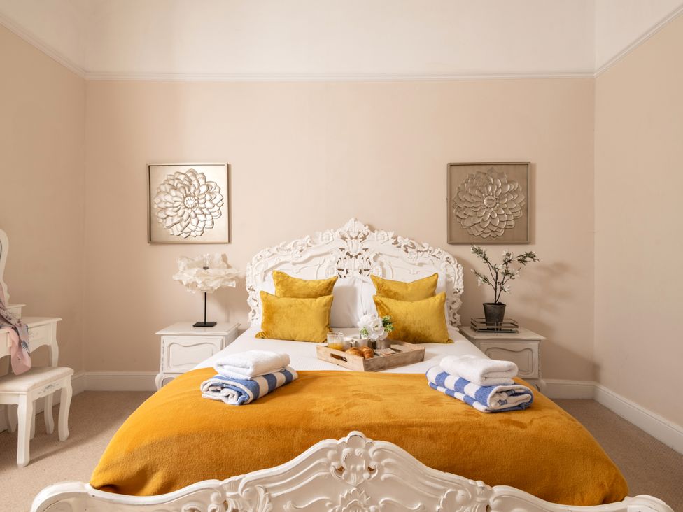 A bedroom with a bed and bedside tables at The Downwood in Blandford Forum