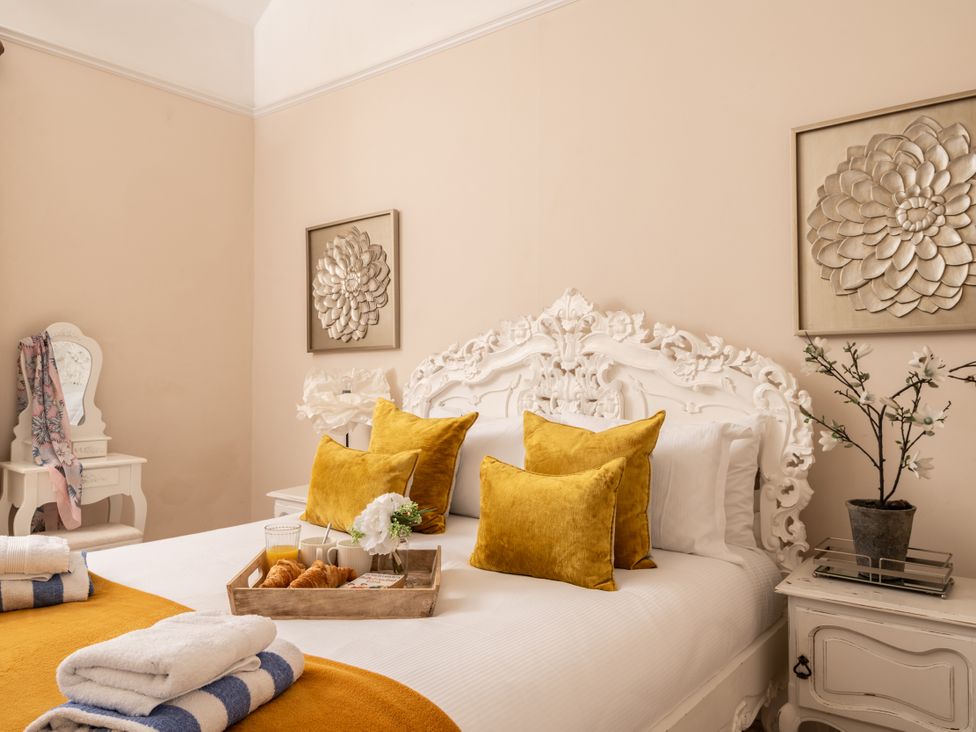 A bedroom with a bed and pillows at The Downwood in Blandford Forum