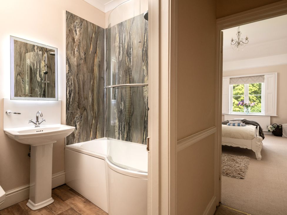 A bathroom with a bathtub and sink at The Downwood in Blandford Forum