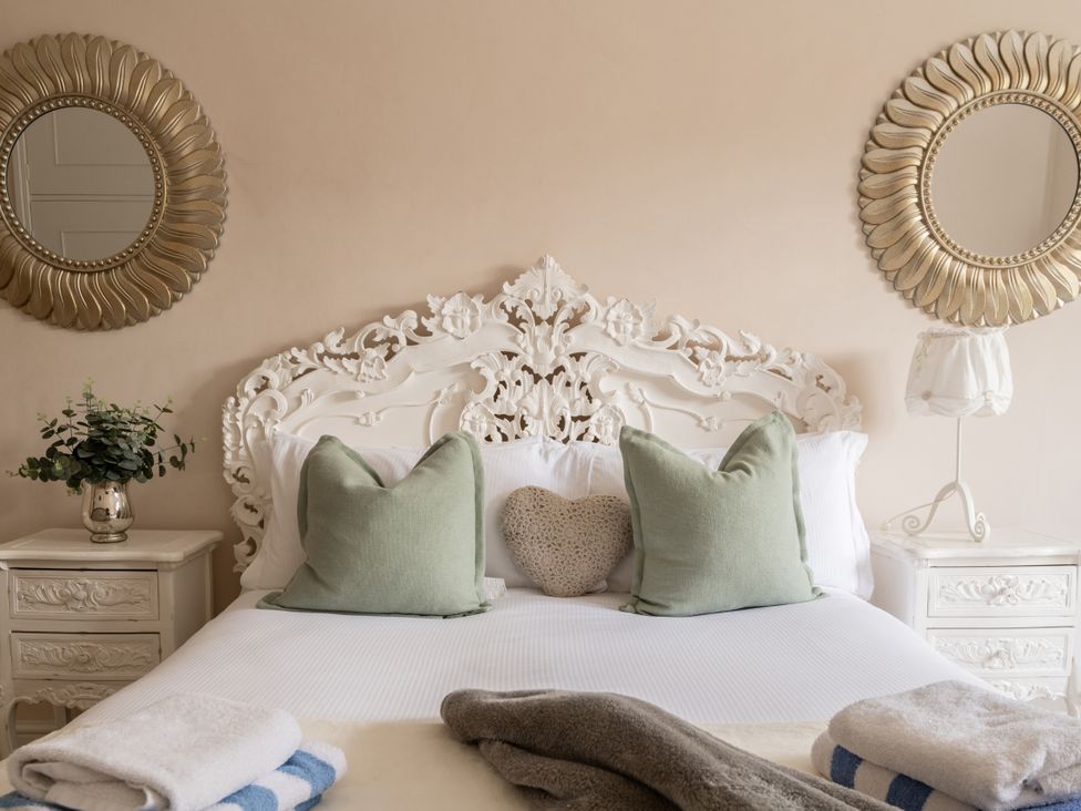 A bedroom with a bed and pillows at The Downwood in Blandford Forum