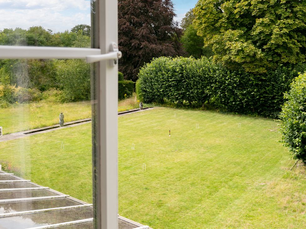 A garden view with grass and statues at The Downwood in Blandford Forum