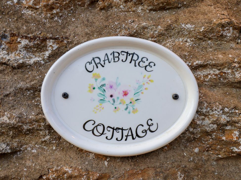 A nameplate on a stone wall at Crabtree Cottage in Suffield near Scalby