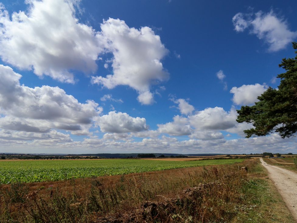 A field with clouds and a road at Crabtree Cottage in Suffield near Scalby
