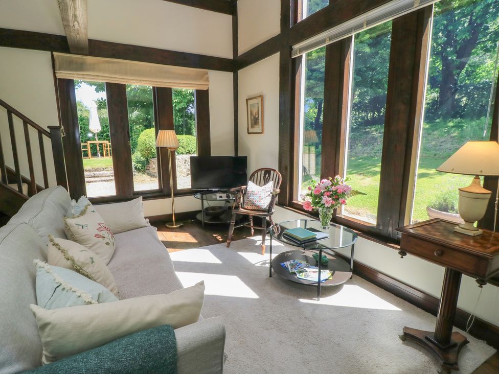 A living room with a sofa and television at The Barn at Frog Pond Farm Antsy near Tisbury