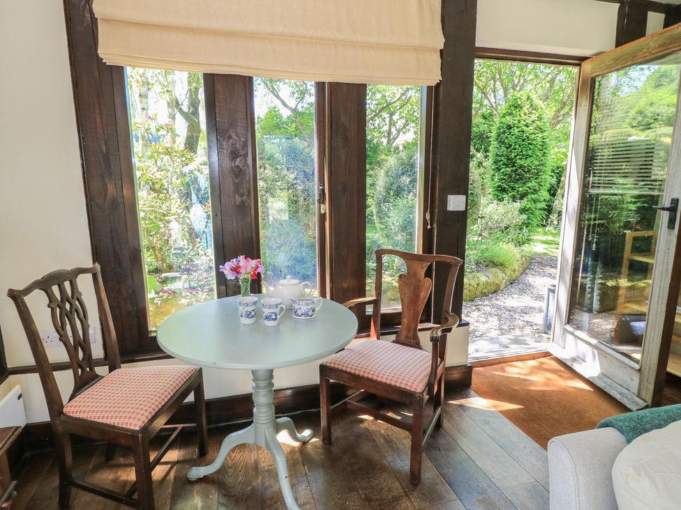 A dining area with a table and chairs at The Barn at Frog Pond Farm Antsy near Tisbury