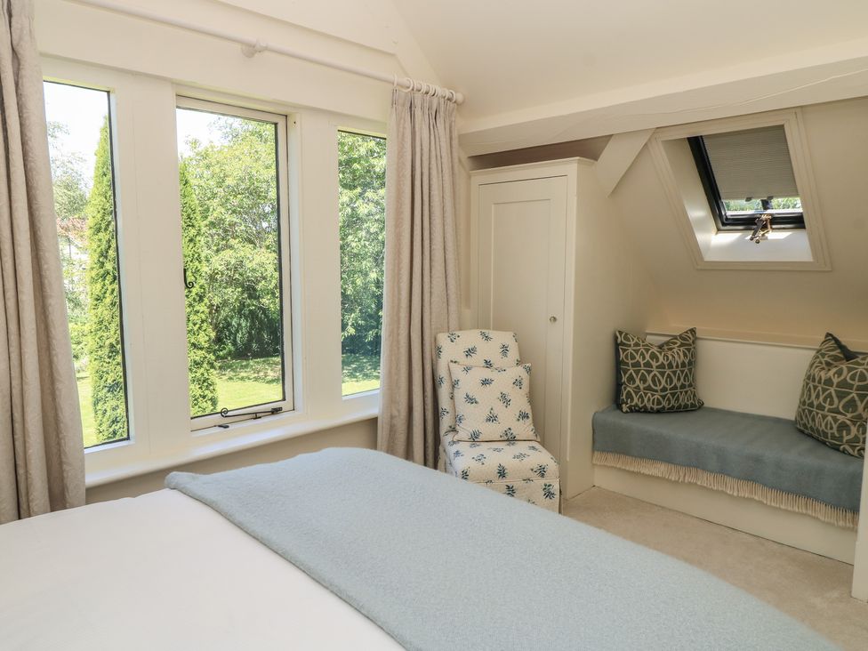 A bedroom with a bed and windows at The Barn at Frog Pond Farm Antsy near Tisbury