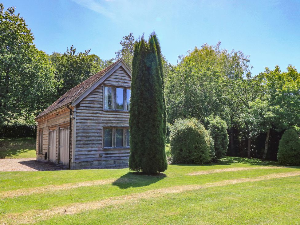A house surrounded by trees and grass at The Barn at Frog Pond Farm Antsy near Tisbury