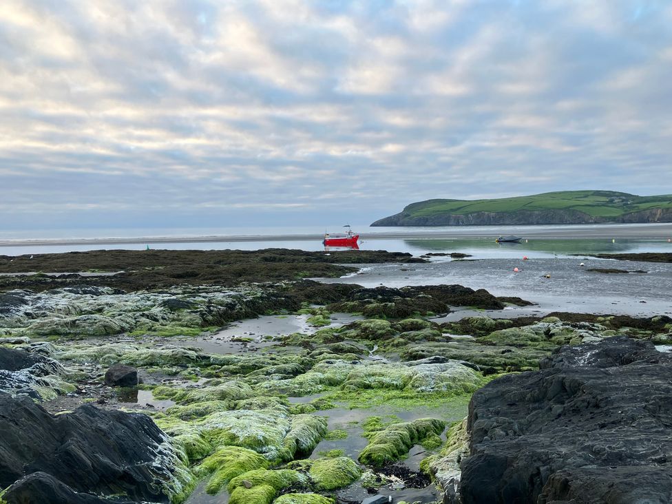 A coastal view with boats on water at West End Cottage Newport, Pembrokeshire