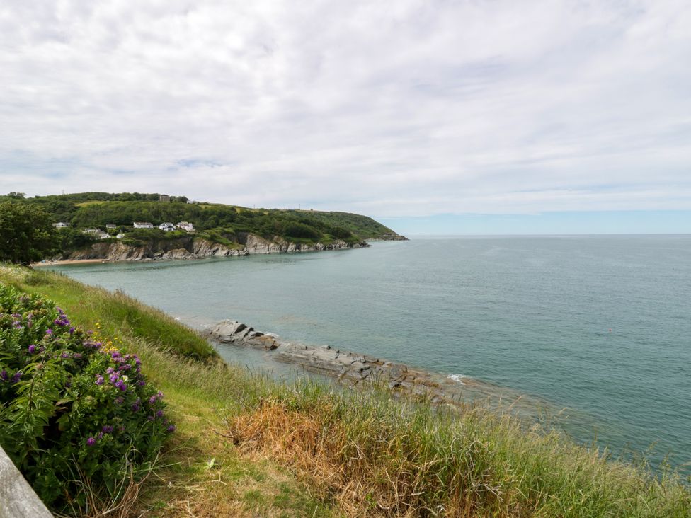 A coastline with cliffs and ocean at Clifftop Carriage in Aberporth, Ceredigion