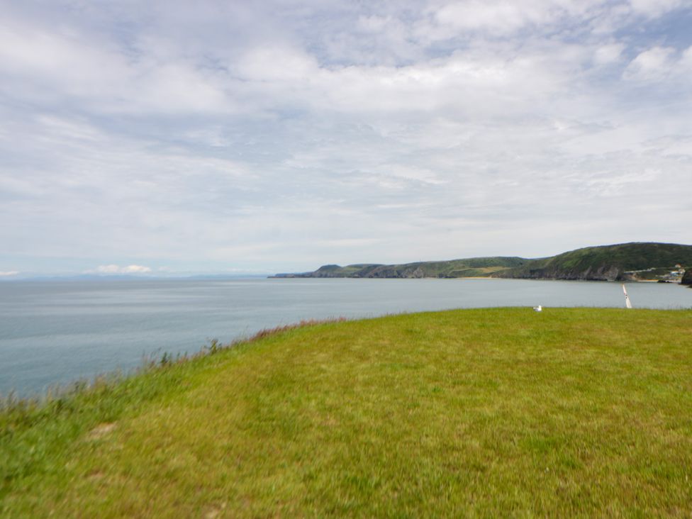 A view of the sea from a grassy area at Clifftop Carriage in Aberporth, Ceredigion