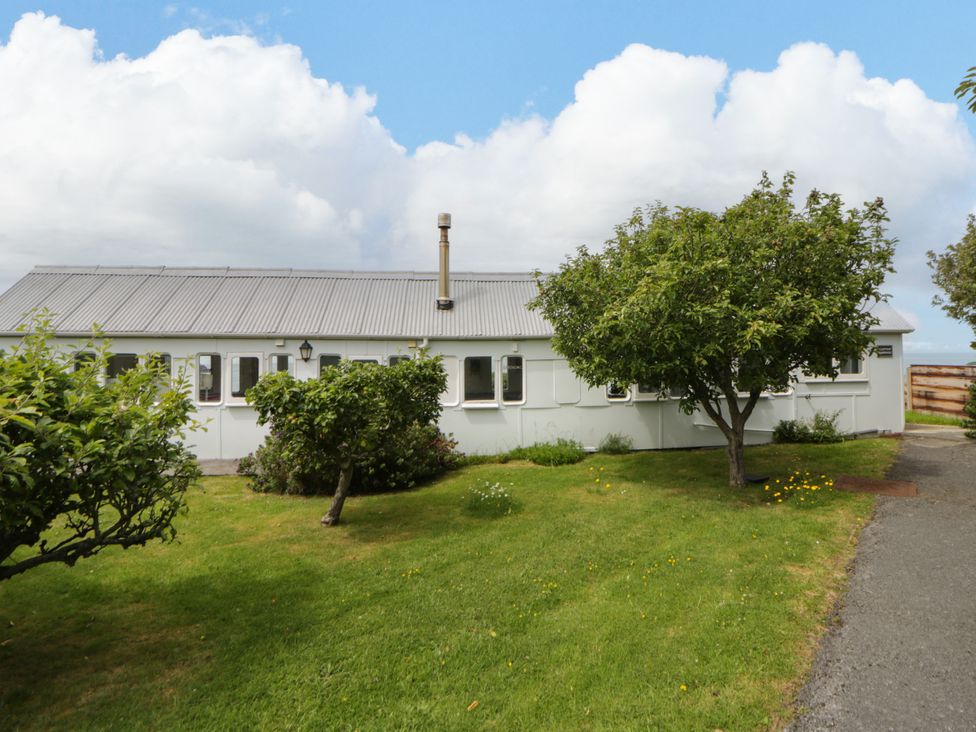 A house with garden and trees at Clifftop Carriage in Aberporth, Ceredigion