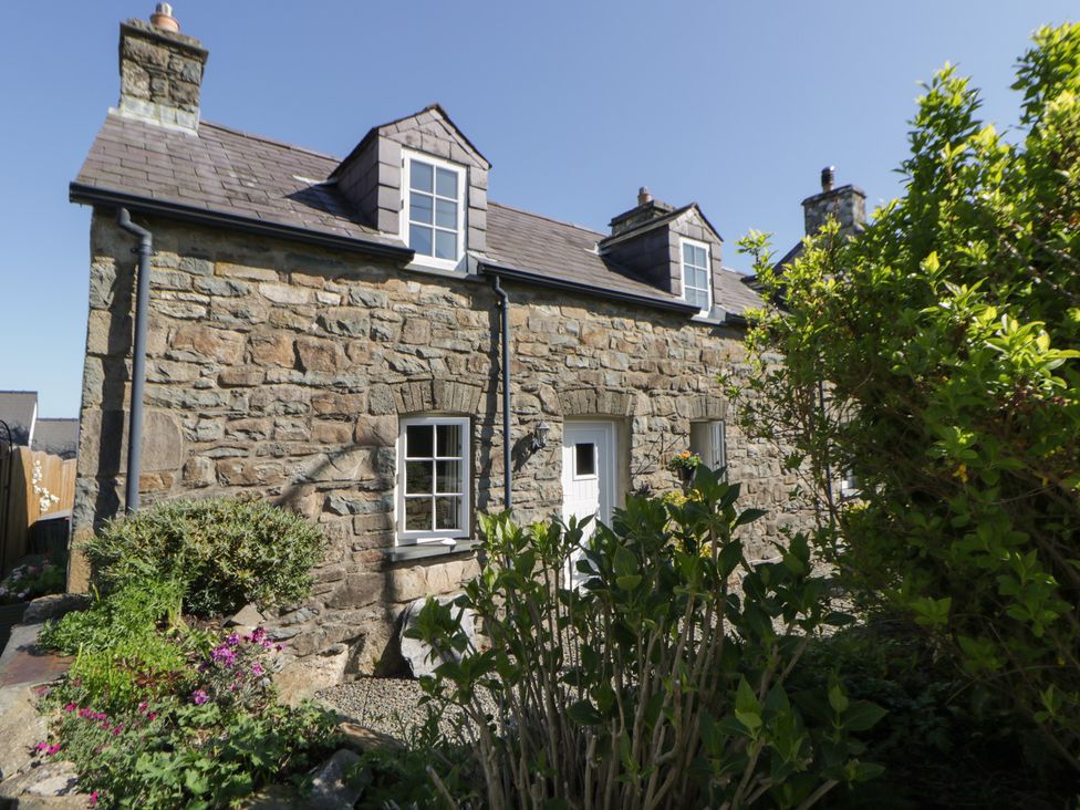 A stone house with windows and a front door at End Cottage Newport, Pembrokeshire