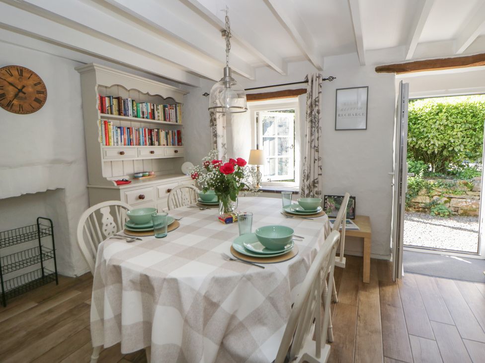 A dining room with a table and chairs at End Cottage in Newport, Pembrokeshire