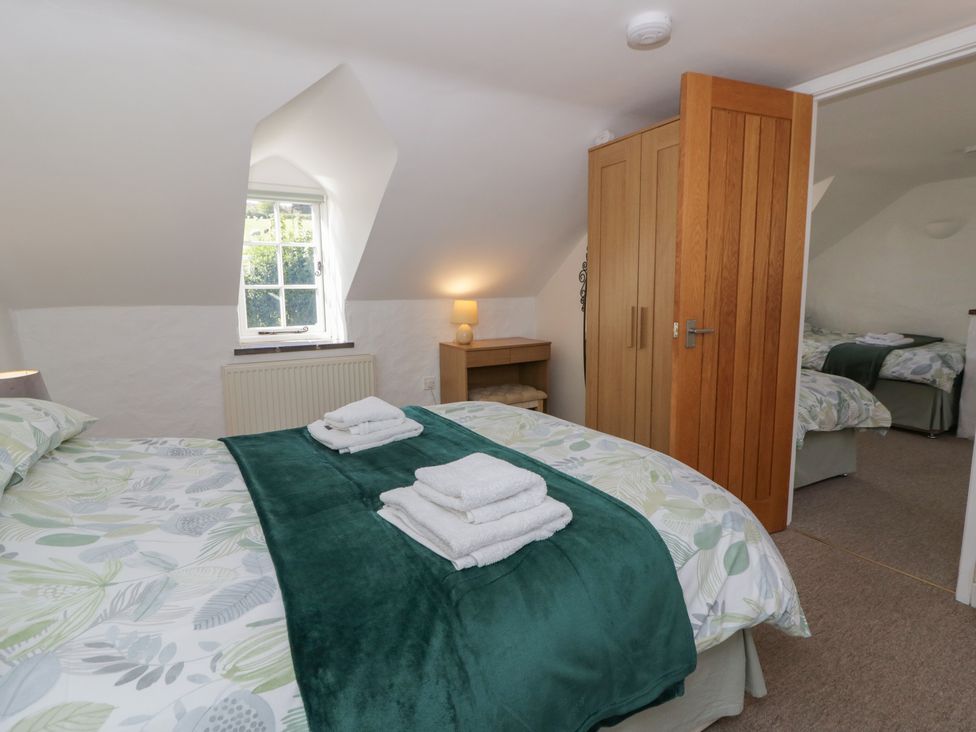 A bedroom with a bed and bedside table at End Cottage Newport, Pembrokeshire