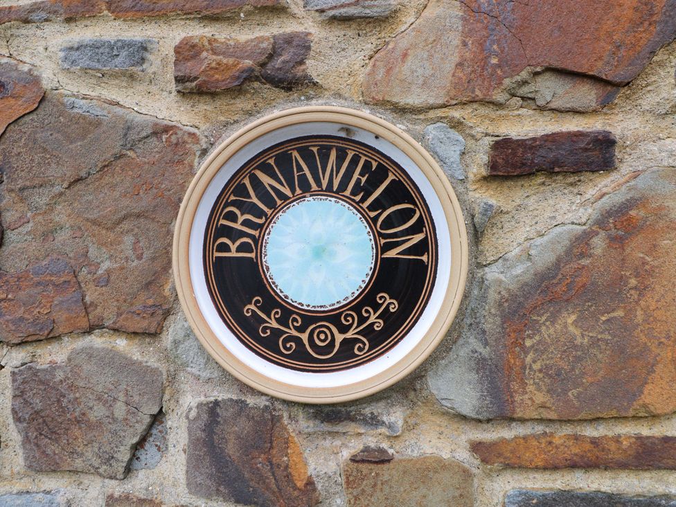 A decorative sign on a stone wall at Brynawelon Newport, Pembrokeshire
