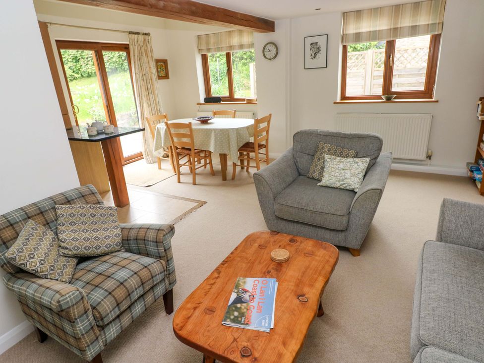 A living room with sofa and dining area at Brynawelon in Newport, Pembrokeshire