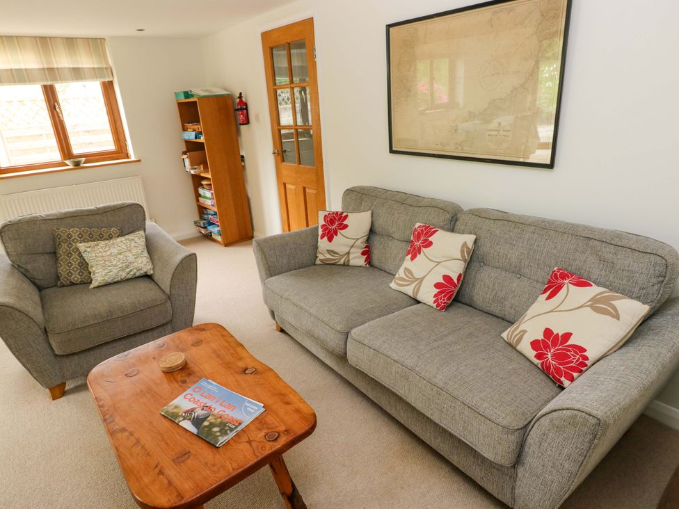 A living room with a sofa and armchair at Brynawelon, Newport, Pembrokeshire
