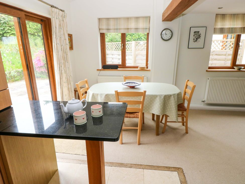 A kitchen with a table and chairs at Brynawelon in Newport, Pembrokeshire