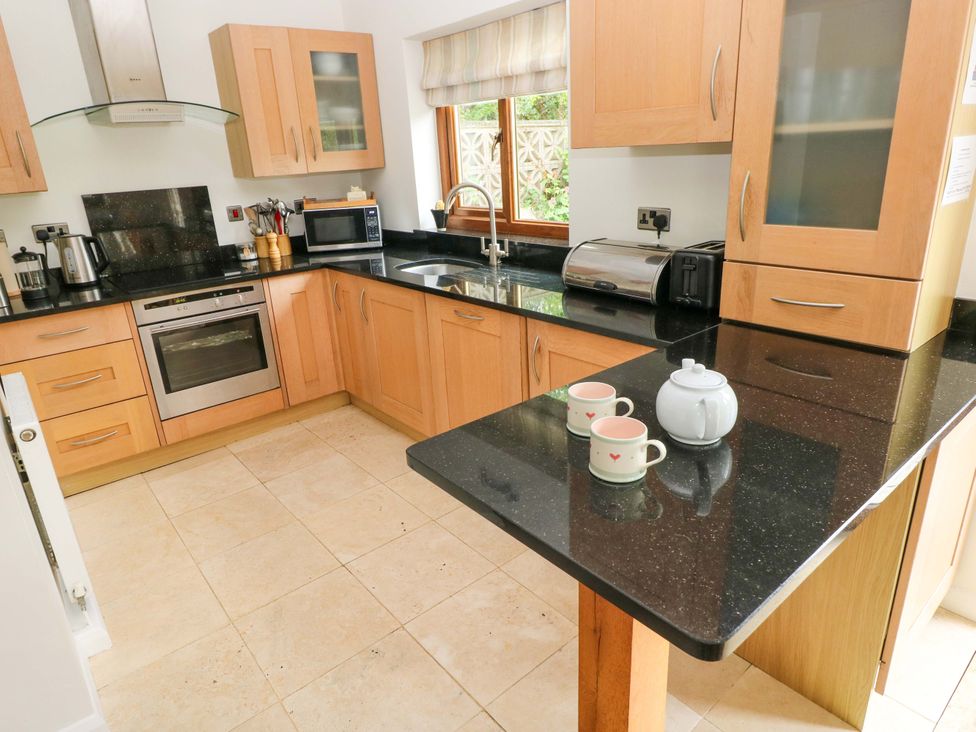 A kitchen with cabinets and appliances at Brynawelon in Newport, Pembrokeshire