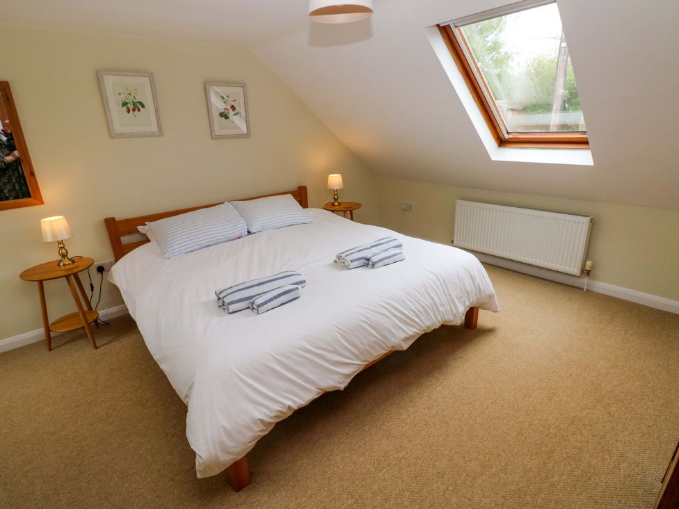 A bedroom with a double bed and bedside tables at Brynawelon Newport, Pembrokeshire