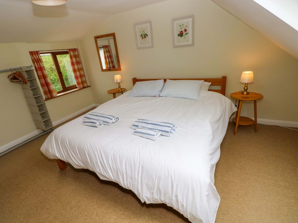 A bedroom with a double bed and window at Brynawelon Newport, Pembrokeshire