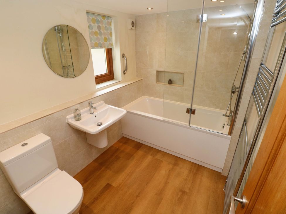 A bathroom with a bathtub and sink at Brynawelon in Newport, Pembrokeshire